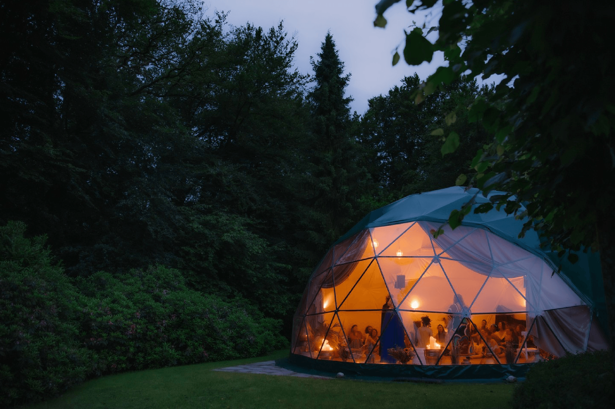 The illuminated geodesic Dome beside the House at New Eden